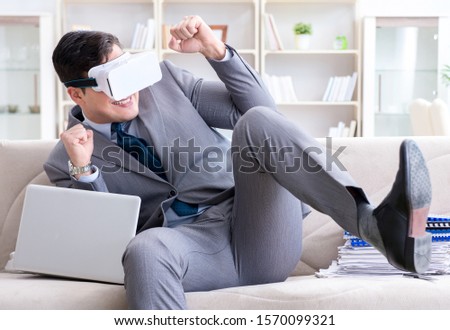 Businessman with virtual reality glasses in modern technology co