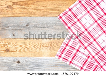 A red white napkin on wooden table as a background