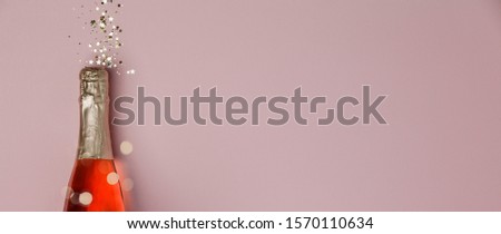 Champagne bottle with christmas decoration on dark background