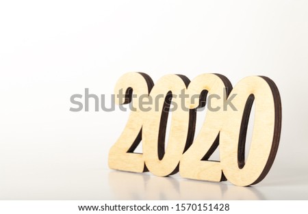 Wooden figures on a light wooden background. Happy new Year theme.