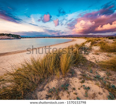 Colorful summer view of Voidokilia beach. Dramatic sunset on the Ionian Sea, Pilos town location, Greece, Europe. Beauty of nature concept background.