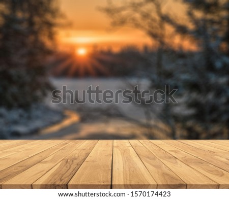 Merry christmas and happy new year greeting background with table .Winter landscape with snow and christmas trees.