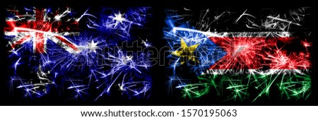 Australia, Ozzie vs South Sudan New Year celebration sparkling fireworks flags concept background. Combination of two abstract states flags.
