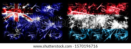 Australia, Ozzie vs Luxembourg New Year celebration sparkling fireworks flags concept background. Combination of two abstract states flags.
