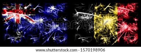 Australia, Ozzie vs Belgium, Belgian New Year celebration sparkling fireworks flags concept background. Combination of two abstract states flags.

