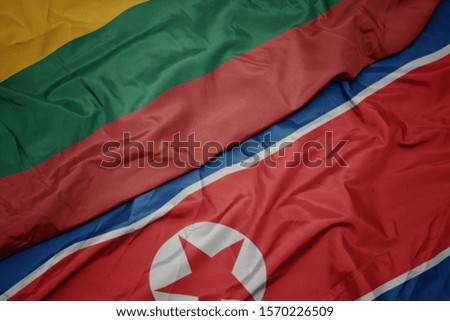 waving colorful flag of north korea and national flag of lithuania. macro