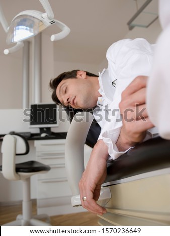Dentist sleeping in dental chair