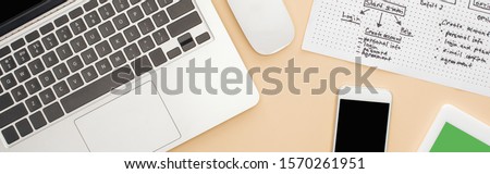 top view of gadgets near website design template on beige background, panoramic shot
