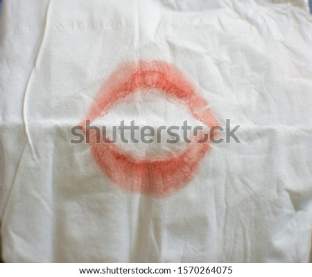 Red lipstick marks on tissue paper