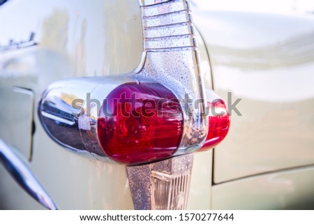 Detail of oldtimer vintage car. The backlight of a retro classic automobile. Royalty-Free Stock Photo #1570277644