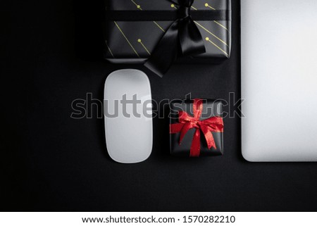 Cyber Monday Sale free space for text with mouse, laptop, hard dirve and gift box on black background. Shopping Online concept and Cyber Monday composition.