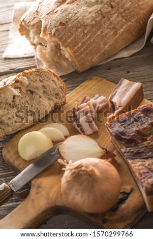 traditional fresh bread with slices od bacon with onion served on wooden plate, european national snack, slovak food 