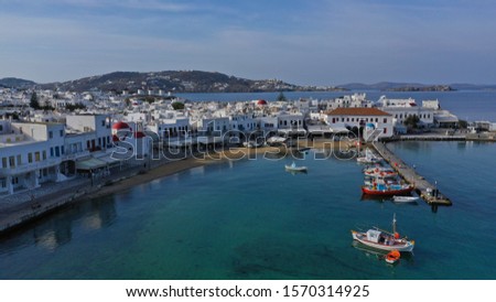 Aerial drone photo of traditional wooden fishing boat in old port of Mykonos island,  Cyclades, Greece