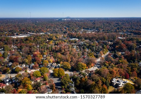 Aerial picture of houses in Midtown Atlanta during the fall and Stone Mountain in the background