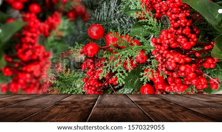Christmas holiday table. Empty festive scene, wooden table. Lanterns and balls, beads on the branches of a Christmas tree. Christmas toys and decorations. Christmas and New Year background.
