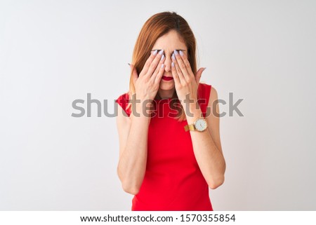 Redhead businesswoman wearing elegant red dress standing over isolated white background rubbing eyes for fatigue and headache, sleepy and tired expression. Vision problem