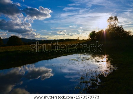 Reflection of the evening Sky in a Puddle near Hemer Deilinghofen in the Sauerland Germany on a summer evening at dusk
