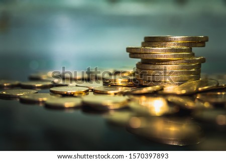 Gold coins stacks is representing riches and wealth management. Coin stack growing and find out the way to get a return on investment. Finance and money exchange investment as concept. Royalty-Free Stock Photo #1570397893