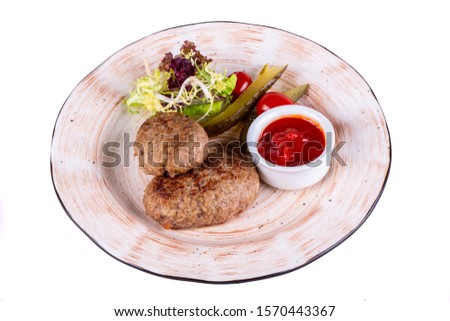 Beef meat cutlets, served with ketchup and salts