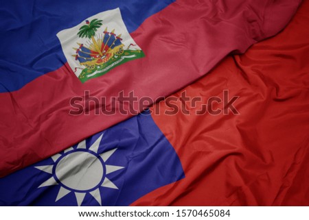 waving colorful flag of taiwan and national flag of haiti. macro