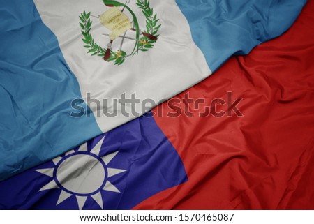 waving colorful flag of taiwan and national flag of guatemala. macro