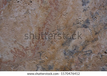 Wall of travertine with stone layers of different colors. Close up architecture macro photography. Creative wallpaper photography.