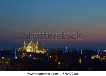 A church decorated with feast lights in Malta on a clear summer sunset evening.