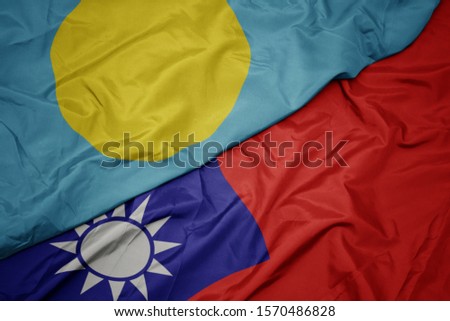 waving colorful flag of taiwan and national flag of Palau . macro