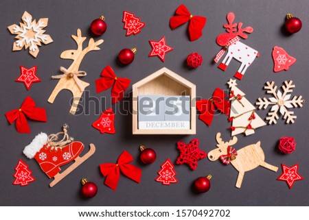 Christmas black background with holiday toys and decorations. Top view of wooden calendar. The twenty fifth of December. Merry Christmas concept.