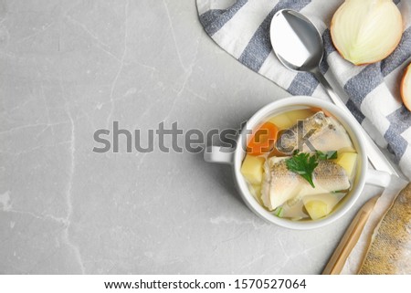 Delicious fish soup served on light table, flat lay. Space for text