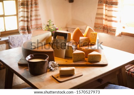 A selection of cheeses on table in Oberstaufen, Allgau, Allgaeu, Bavaria, Germany Royalty-Free Stock Photo #1570527973