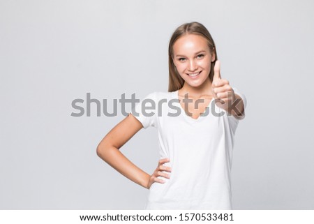 casual woman smiling with her thumbs up - isolated