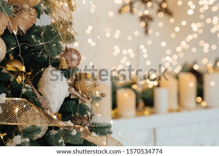 A beautiful studio decorated for holidays. Beautiful candles on the fireplace.  Positive emotions, joy. Festive Christmas winter. Happy New Year. 