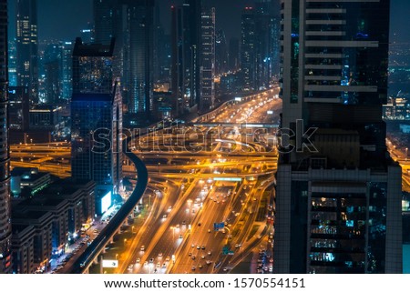 Busy traffic in downtown Dubai at night, UAE road and transport abstract