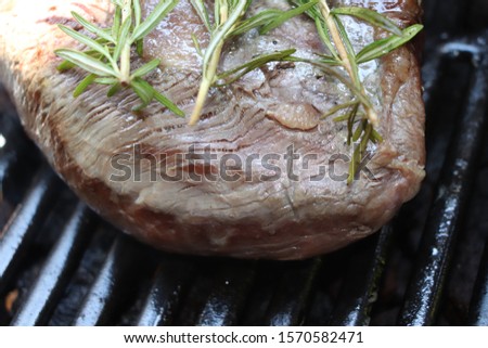 Steak of beef with rosemary cook on the grill
