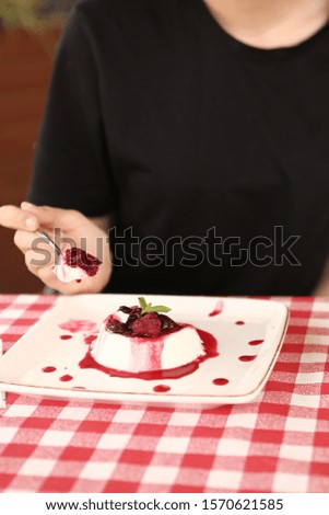A young woman eat a tasty dessert