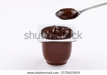 chocolate pudding brown cup plastic  with spoon isolated on white background Royalty-Free Stock Photo #1570625854