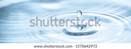 Water drop splash blue color. Droplet of water splashes close up abstract background. Fresh pure aqua. Simple minimal background of pure natural clean water.
