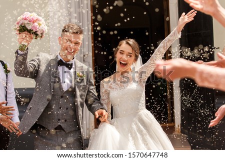Happy wedding photography of bride and groom at wedding ceremony. Wedding tradition sprinkled with rice and grain Royalty-Free Stock Photo #1570647748