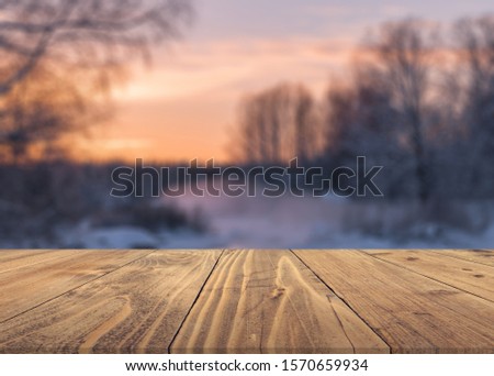 Merry christmas and happy new year greeting background with table .Winter landscape with snow and christmas trees.