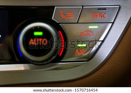 Selective focus of Vehicle Air Conditioning Control System. AC, Recirculation Button on dashboard in luxury car Royalty-Free Stock Photo #1570716454