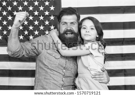 Saluting the great banner. Patriotic family celebrating flag day with banner decor. Father and little daughter on american banner background. Bearded man and small child with national us banner.