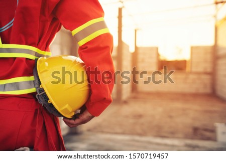 Engineer holding helmet at construction site,safety concept Royalty-Free Stock Photo #1570719457