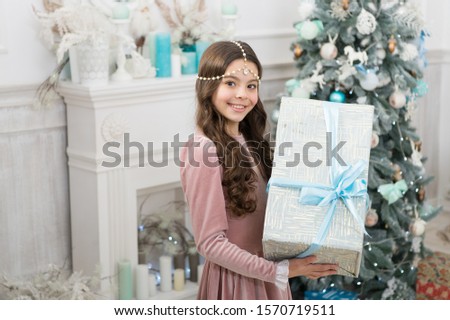 Boxing day. Open gift. Winter wonderland. Adorable girl hold big box christmas eve. Present concept. Smiling child enjoy winter holidays. Winter vacation. Winter decorations. Magical atmosphere.