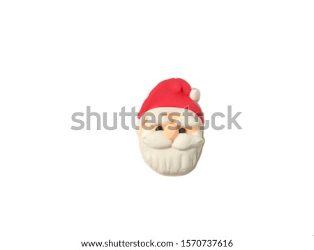 Cute face Santa Claus handmade from plasticine clay on white background, beautiful festival are dough