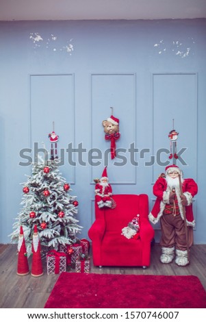 Christmas with decorated a tree with Happy New Year on blue .Mary christmas interior with new year pime tree decorated. Christmas red armchair and gifts. Santa Klaus . Christmas photozone decorated