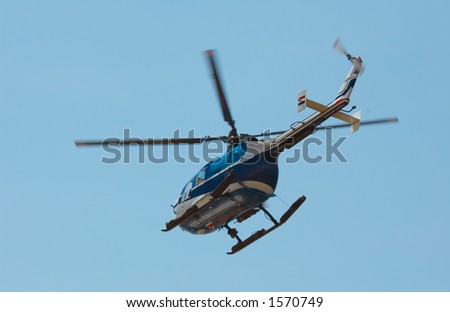 Photo of a helicopter against a blue sky