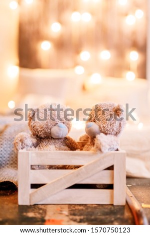 New Year 2020. New Year mood. Children's toys, bears in the lights. Cozy composition with books. Close-up.