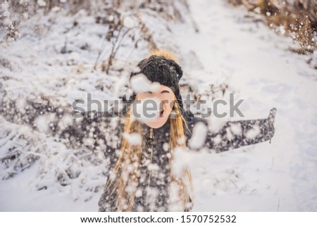 Woman has fun in winter, throws snow