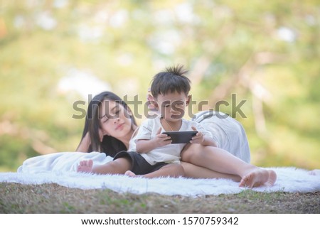 Portrait of asian mother playing with newborn boy, boy talking to mother. Health care family love together. Asian girl lifestyle. Asia mother's day concept, Mom's love. Mother breast feeding baby. 